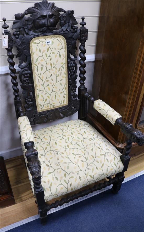 A Victorian Carolean style carved oak armchair
